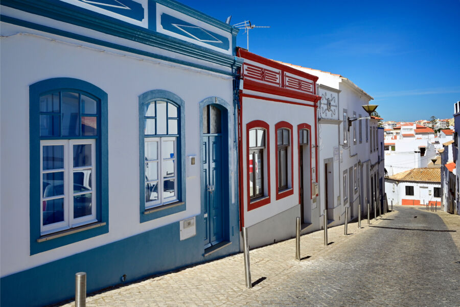 Historic Rua da Porta da Vila in Portugal, showcasing charming architecture and vibrant street life
