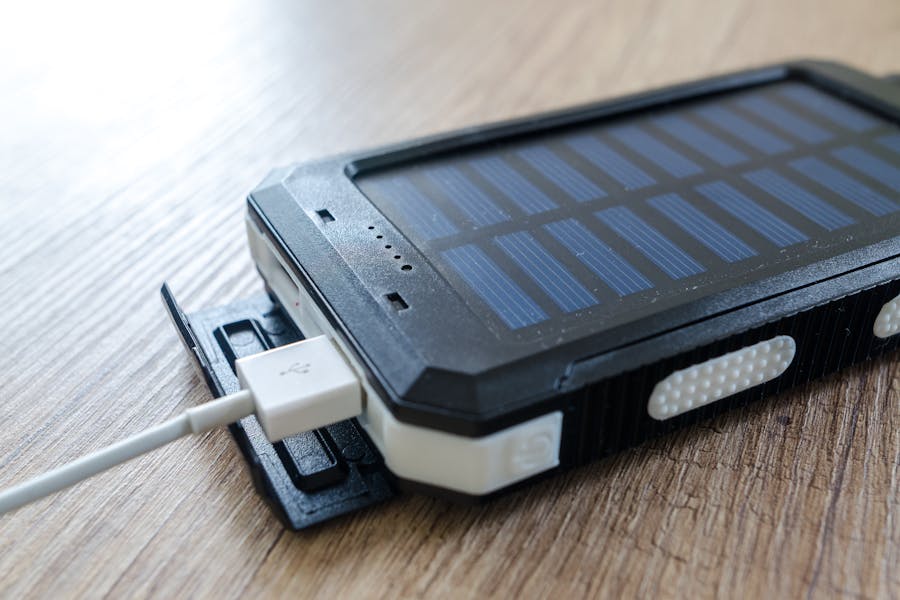 Rugged solar-powered smartphone with durable design on wooden surface, highlighting eco-friendly technology.