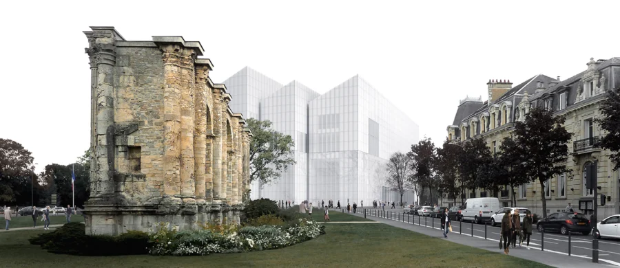 Museum with ancient stone ruins beside modern glass building in urban park.