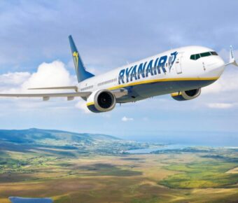 Ryanair BoeinsHow to Get Refund on Canceled Ryanair Flight: 5 Insider Steps for Fast Compensationg 737 flying over scenic European landscape with hills and ocean.