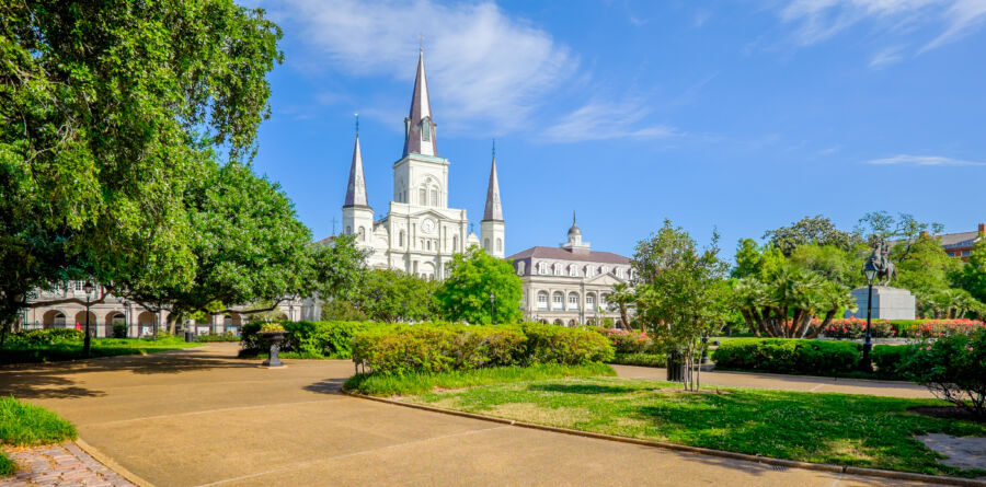 The iconic Saint Louis Cathedral at Jackson Square, framed by the New Orleans skyline, showcases the city's historic architecture