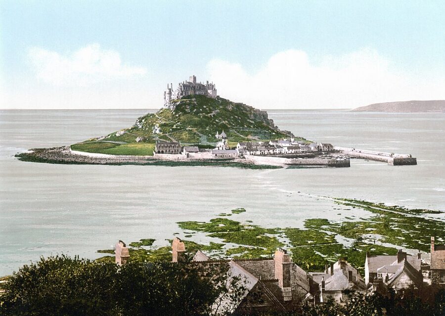 Panoramic view of Saint Michael's Mount, featuring a castle on an island in Cornwall, framed by the ocean.
