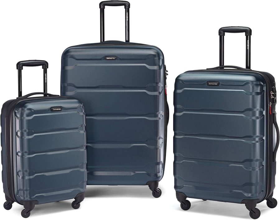 Three Samsonite Omni PC hardside expandable luggage pieces with wheels and handles, arranged for display.