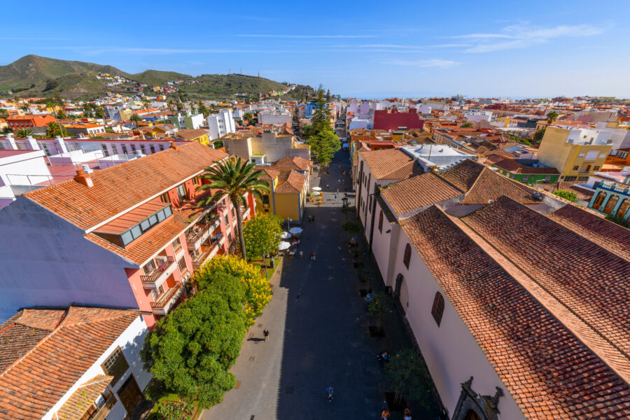 Panoramic image of San Cristóbal de La Laguna, highlighting its colorful buildings and lush surroundings in Tenerife, Spain