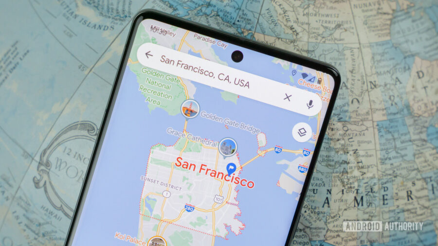 Smartphone displaying San Francisco map, landmarks highlighted, emphasizing digital navigation and modern design.