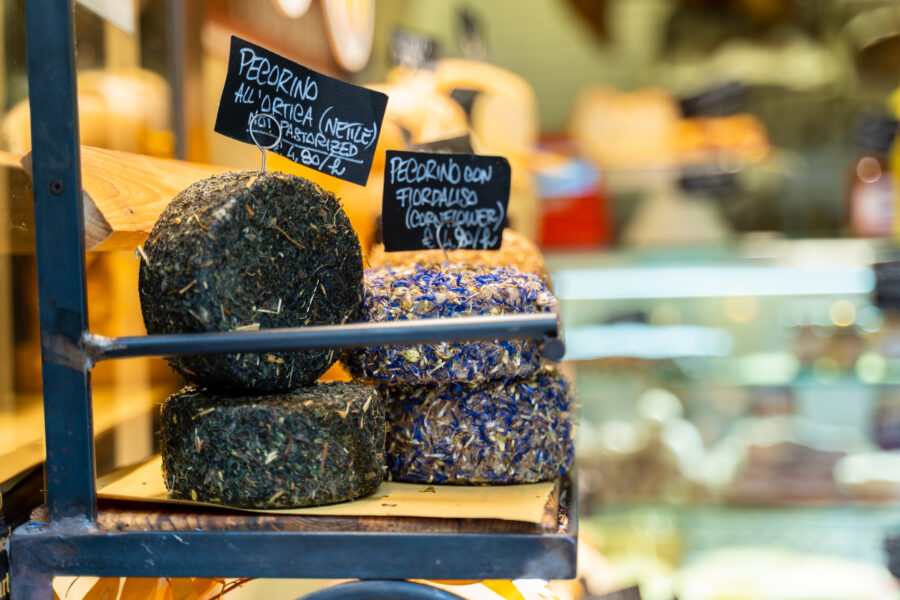 Close-up of traditional Italian pecorino cheese, showcasing its texture and color in San Gimignano, Tuscany, Italy