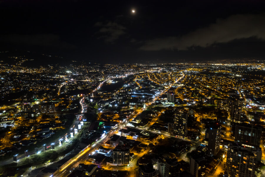 Stunning aerial view of San Jose, Costa Rica at night, filled with twinkling lights across the cityscape