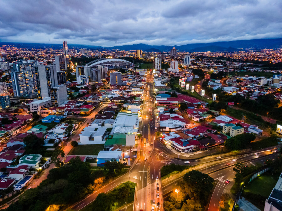 Nighttime aerial view of San Jose, Costa Rica, highlighting the city's bright lights and urban landscape
