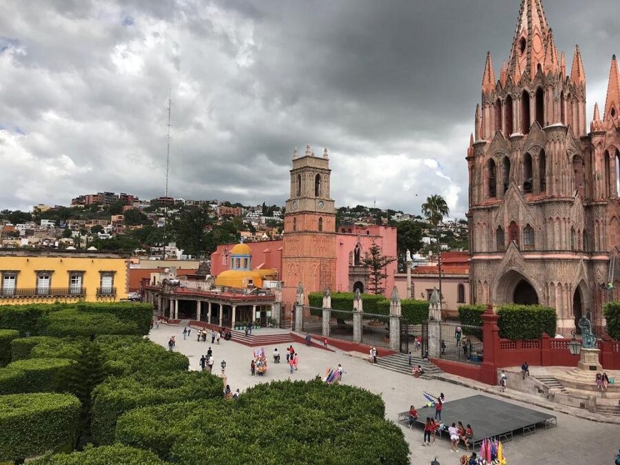 Scenic overlook of San Miguel Allende, highlighting the vibrant cityscape and lush hills in the background.

