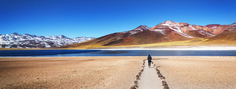 Tourist admires the stunning winter landscape of the Atacama Desert in San Pedro de Atacama, Northern Chile.
