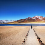Tourist admires the stunning winter landscape of the Atacama Desert in San Pedro de Atacama, Northern Chile.