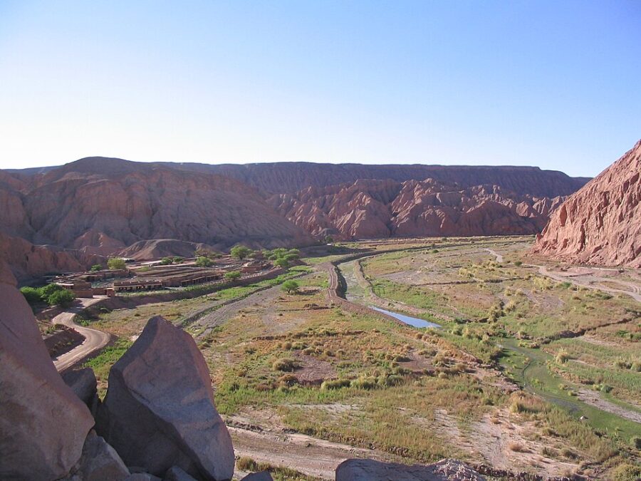 Scenic overlook of the valley from a high elevation in San Pedro de Atacama, Chile, highlighting the rugged terrain and vast sky.