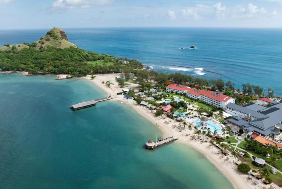 Aerial view of Sandals Grande St. Lucian Spa and Beach, showcasing the resort and its beautiful sandy beach.