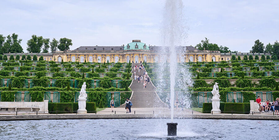 Sanssouci Palace Gardens: Majestic fountains, terraces, and historical architecture in Potsdam, Germany.