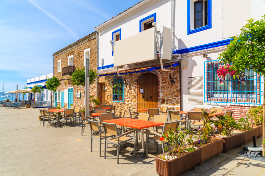 Scenic view of restaurants and bars along the coastal promenade in Santa Eularia, Ibiza, Spain, bustling with visitors