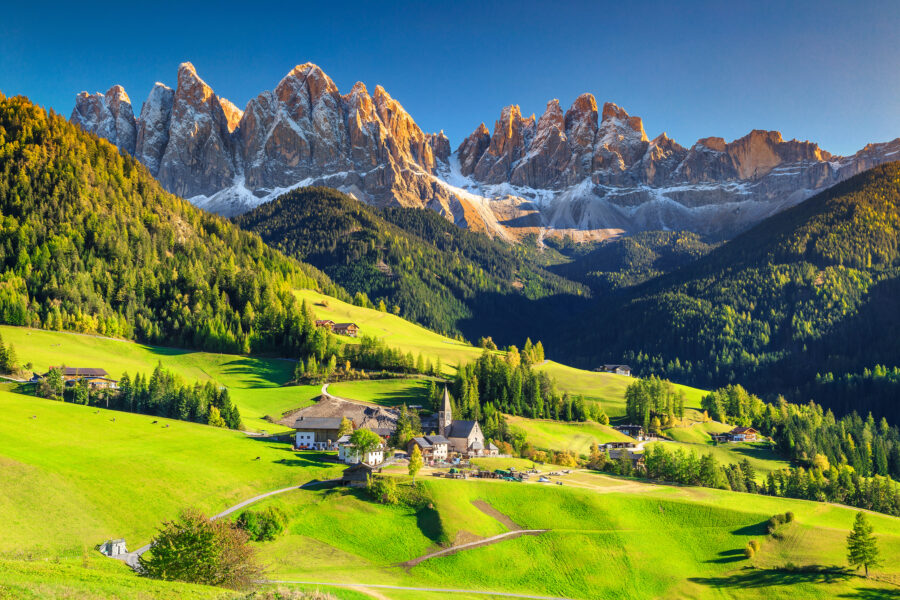 Spring landscape featuring Santa Maddalena village nestled in the Dolomites, Italy, with vibrant greenery and majestic mountains