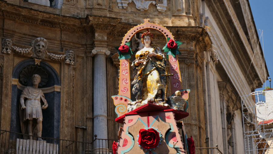 Statue of Santa Rosalia atop the Carro Trionfale during the festival in Palermo, Sicily, surrounded by festive decorations