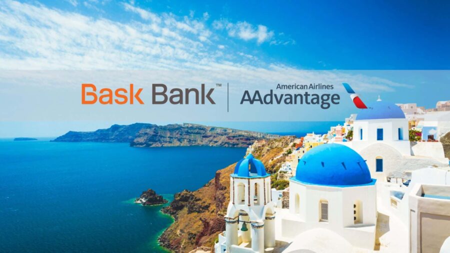 Santorinis stunning coast with white-and-blue domes, sea views, Bask Bank, and AAdvantage branding.