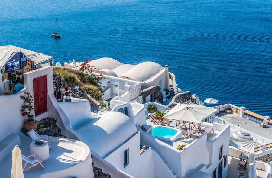 Aerial view of Santorinis Cycladic architecture with whitewashed buildings and stunning sea.