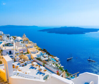 Santorinis whitewashed buildings, Aegean Sea views, volcanic island; Mediterranean paradise.