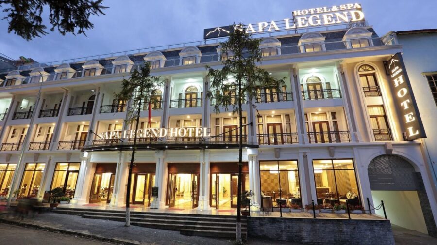 Sapa Legend Hotel & Spa illuminated facade at dusk in Sapa Vietnam, luxury accommodation.