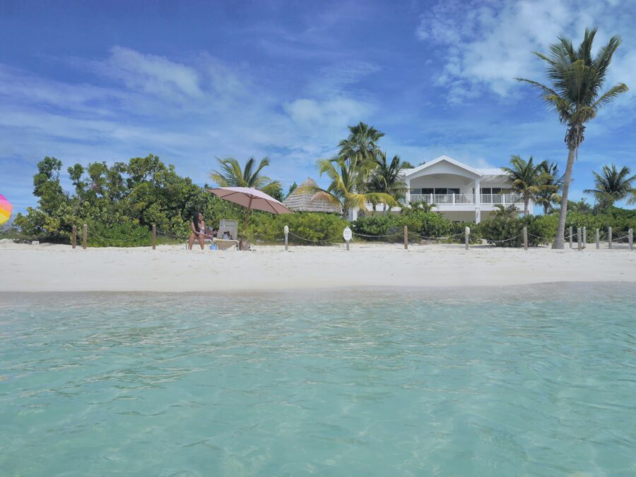 White sand of a tropical beach with turquoise water in Sapodilla Bay, Providenciales, Turks and Caicos.