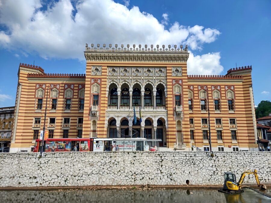Neo-Moorish Vijećnica in Sarajevo: historic architecture, cultural hub, restored post-war, urban setting.