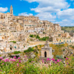 Panoramic view of Matera's Sassi district, featuring historic stone architecture and dramatic landscapes in Basilicata, Italy