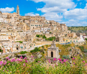 Panoramic view of Matera's Sassi district, featuring historic stone architecture and dramatic landscapes in Basilicata, Italy