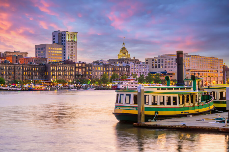Scenic view of the Historic District waterfront in Savannah, Georgia, showcasing historic buildings and the river.
