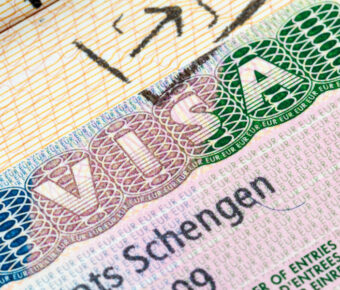 Detailed view of a Schengen visa in a passport, highlighting the unique design elements of a visa stamp