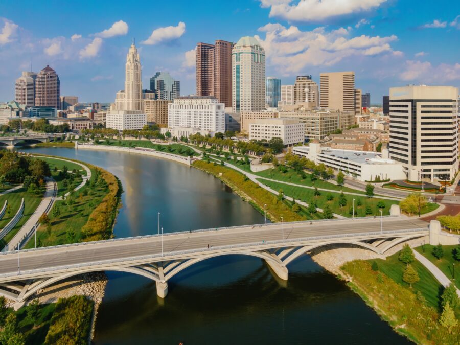 Scenic view of Columbus, Ohio, showcasing modern buildings and green parkland by the Scioto River