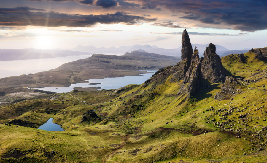Scenic mountain panorama of the Old Man of Storr on the Isle of Skye, Scotland, with the sun shining brightly.
