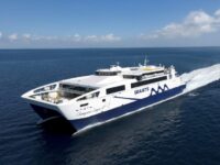 High-speed Seajets Champions League 1 catamaran ferry cruising on calm blue Aegean Sea.
