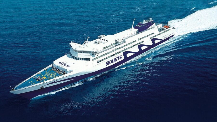 Modern SEAJETS ferry on blue ocean with sleek design, white and purple colors.