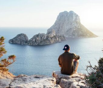 Tourist in a cliff overviewing the beach in Ibiza