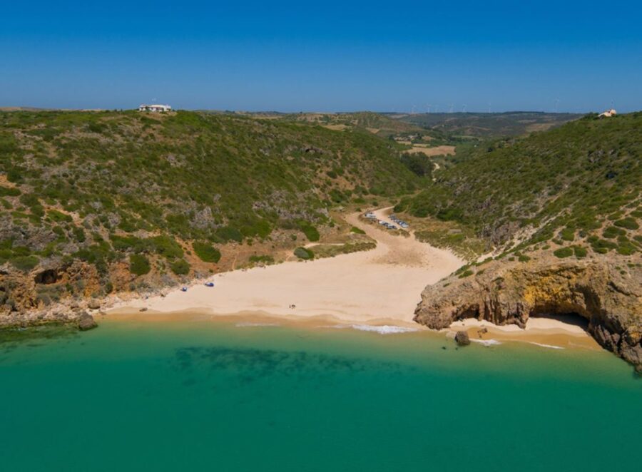 Praia das Furnas secluded cove: turquoise water, sandy beach and rugged cliffs.