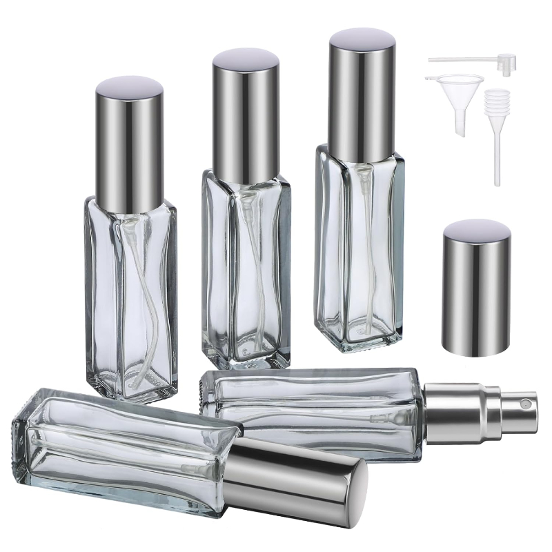 Four glass bottles with metal lids and a small bottle, part of the Segbeauty Mini Perfume Atomizer 5-Pack.