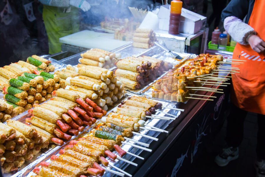 Bustling scene of Seoul street food stalls, showcasing popular items such as spicy rice cakes and savory pancakes