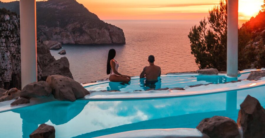 Infinity pool cliffside sunset, serene ocean view, romantic tranquil atmosphere, nature beauty.