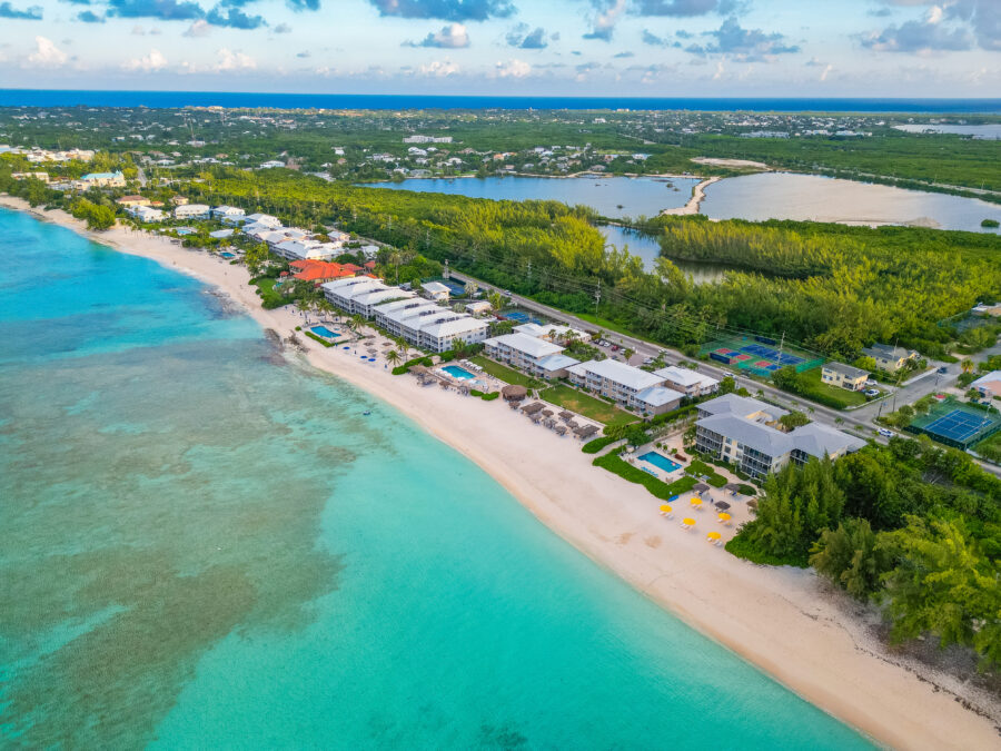 Seven Mile Beach, Grand Cayman, Cayman Islands, with white sand and crystal-clear waters under a blue sky.