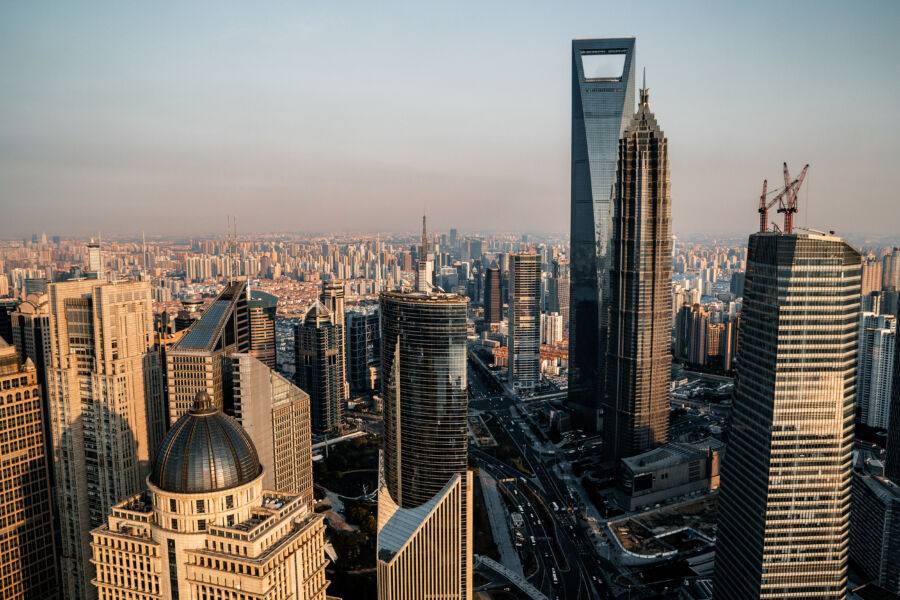 Panoramic view of Shanghai's skyline showcasing modern skyscrapers and vibrant cityscape under a clear blue sky