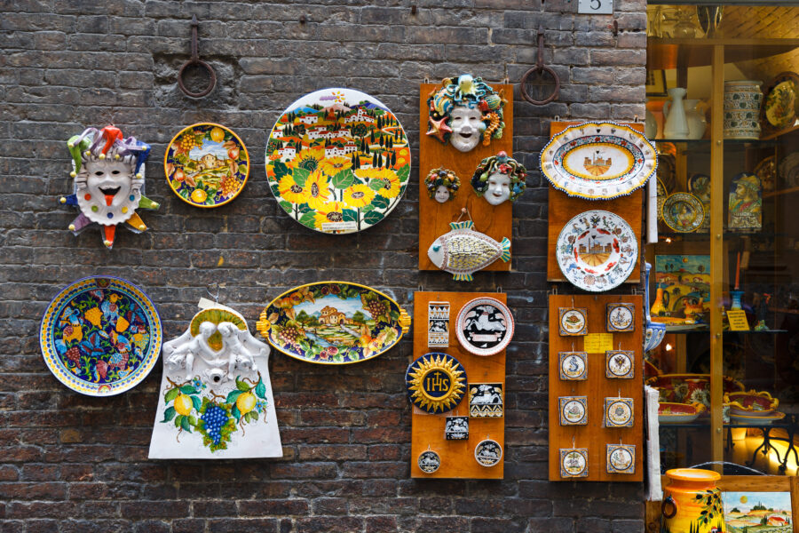 Colorful traditional Italian souvenirs and artistic ceramics displayed on the streets of Siena, showcasing local craftsmanship 