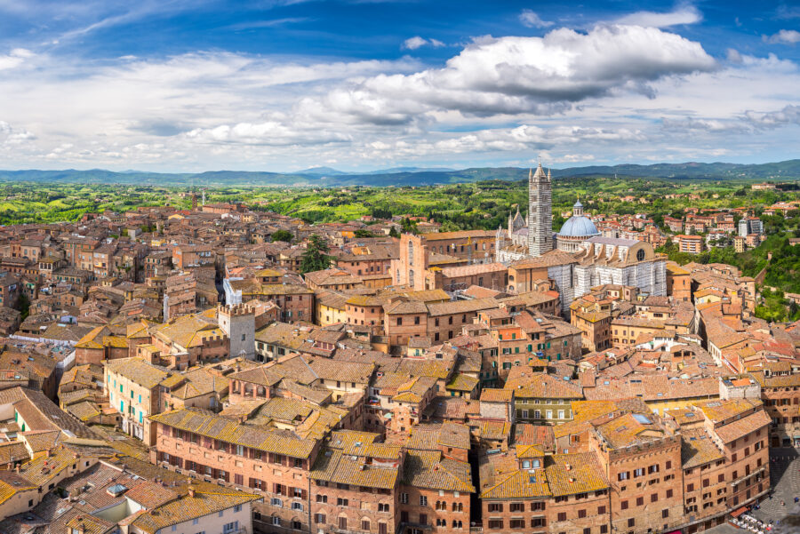 Scenic panorama of Siena, Tuscany, featuring medieval architecture and lush green landscapes