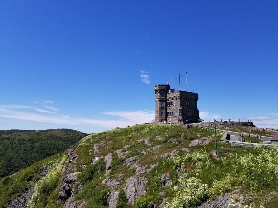 Signal Hill District in St. John’s, Newfoundland, featuring a tower on a hill against a bright blue sky.