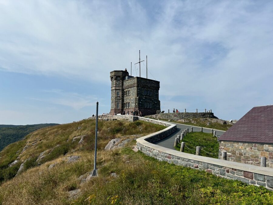 Signal Hill's tower on Signal Hill National Historic Site, with a road winding up to it, set in St. John's, Canada.