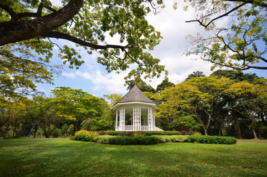 Picturesque view of the Bandstand in Singapore Botanic Gardens, framed by lush trees and plants