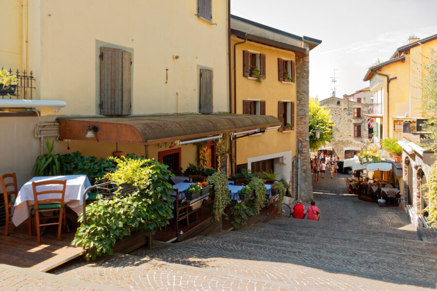 Bright yellow building housing a cafe in Sirmione, Italy, exuding a warm and inviting ambiance.
