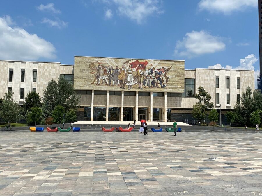 The side of a building in Skanderbeg Square features a striking mural, adding color and character to the urban landscape.