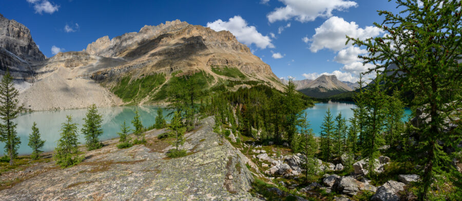 Scenic view of Skoki Lakes surrounded by mountains in Banff National Park, Alberta, Canada, showcasing vibrant blue waters.